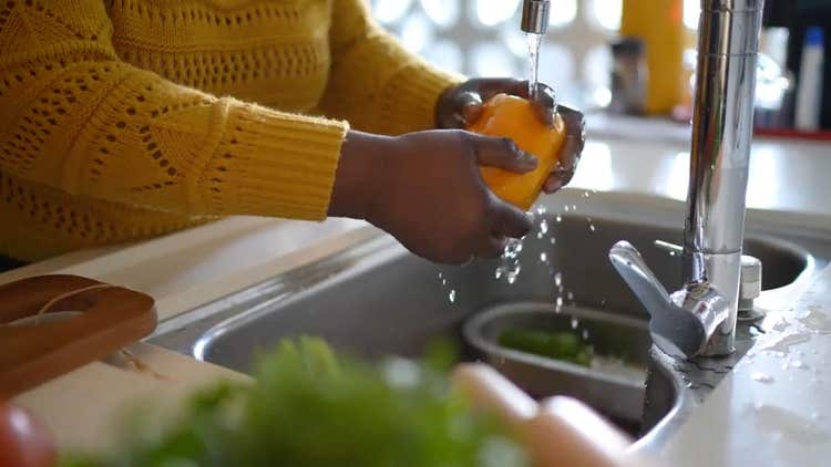 Person washing vegetables