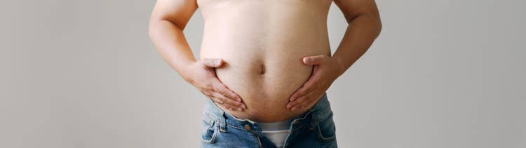 Person's stomach area representing obesity